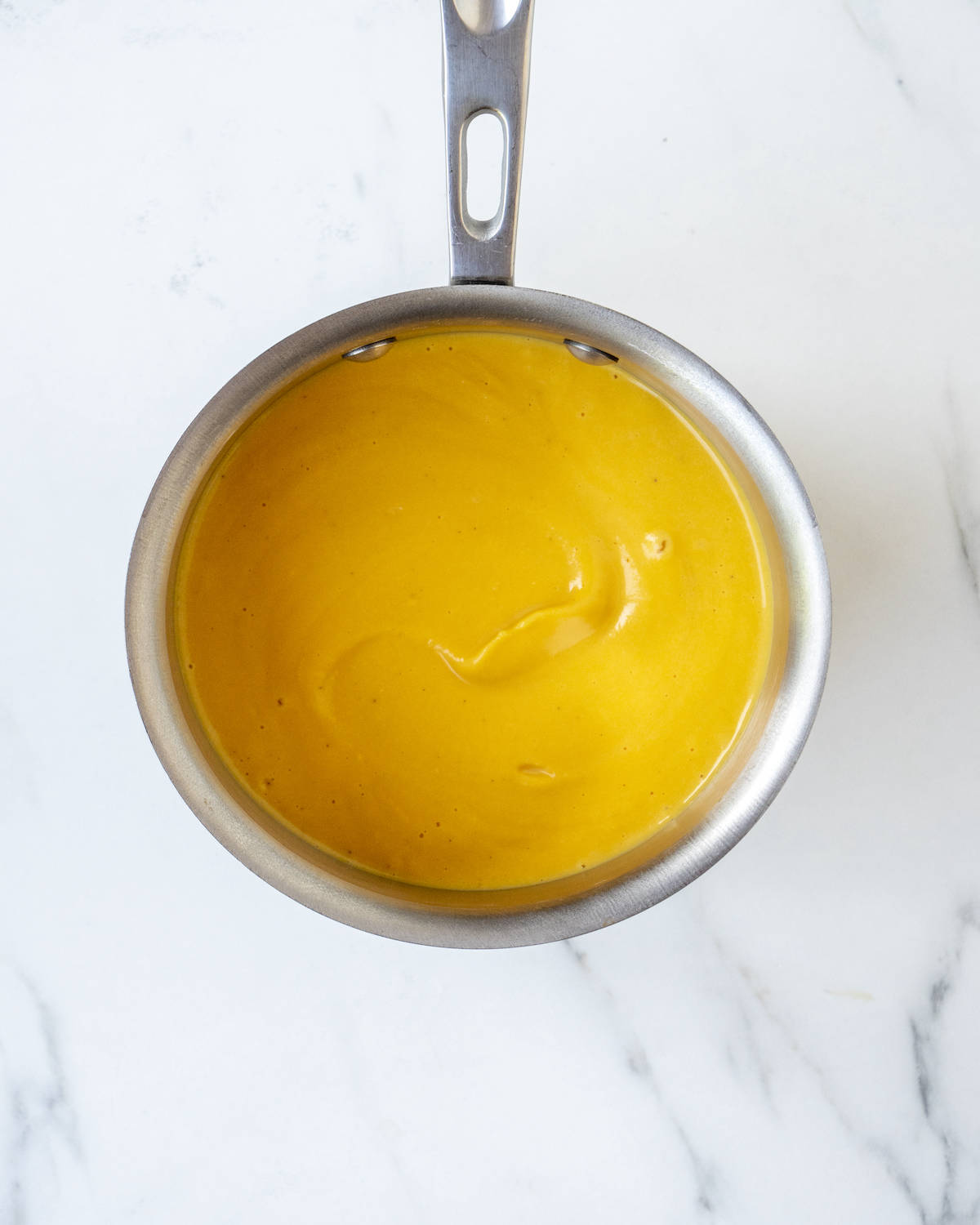 A pot filled with blended butternut squash.  