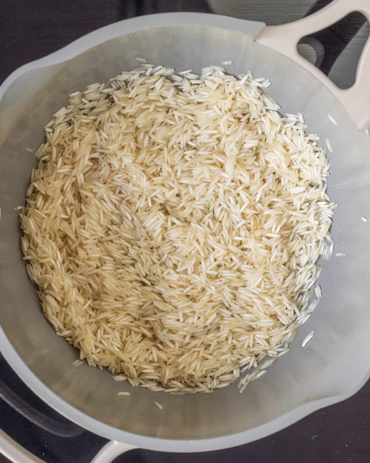 Toasted white rice in a saucepan.